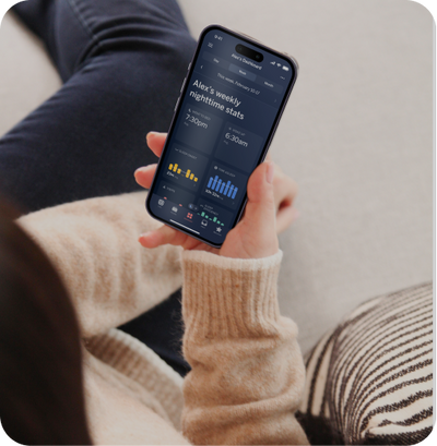 hand holding mobile phone displaying weekly stats on nanit app
