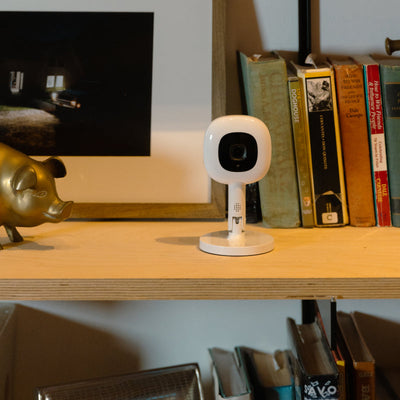 Image of nanit pro camera + flex stand on book shelf