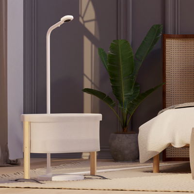 Image of nanit pro camera + floor stand placed in front of small crib in bedroom