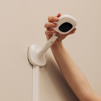 Image of attaching nanit pro camera on wall mount with wall mount mounted on the wall