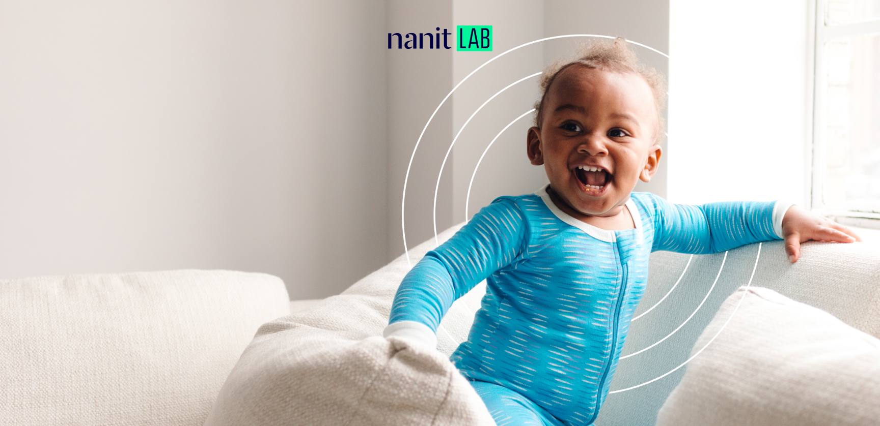 smiling child wearing nanit pajamas