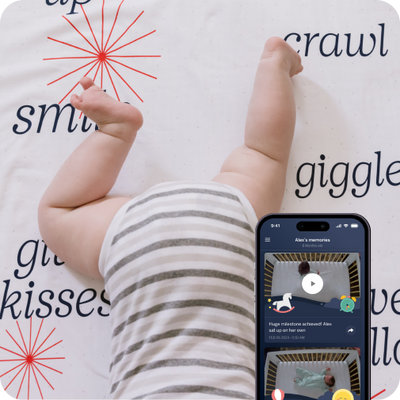 child on blanket with mobile nanit app displayed with view of camera capturing sleep