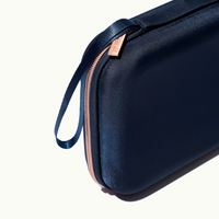 zoomed in picture of rose pink zipper and strap on blue travel case #color_blue